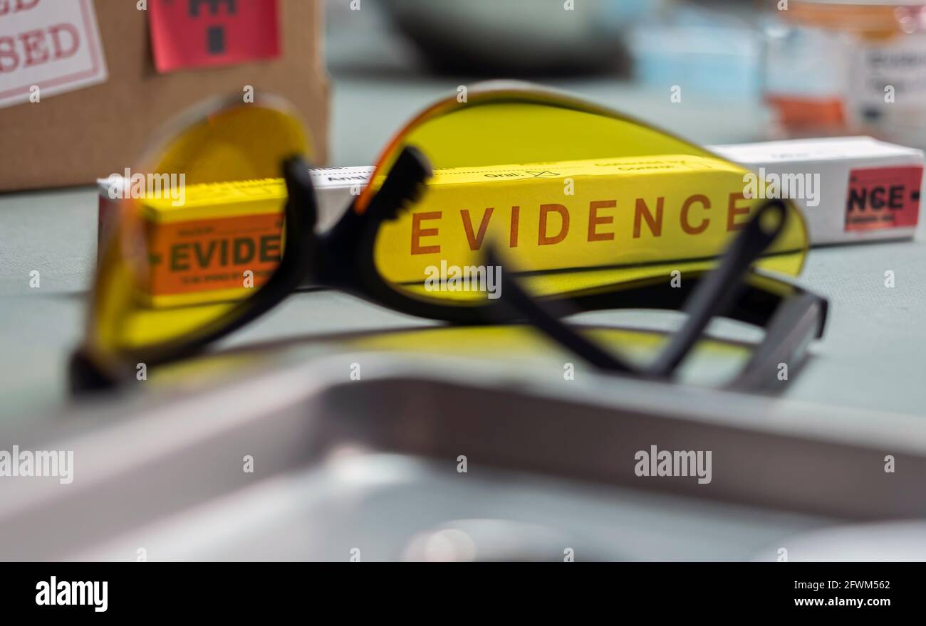 Glasses UV for criminology on police records, conceptual image Stock Photo