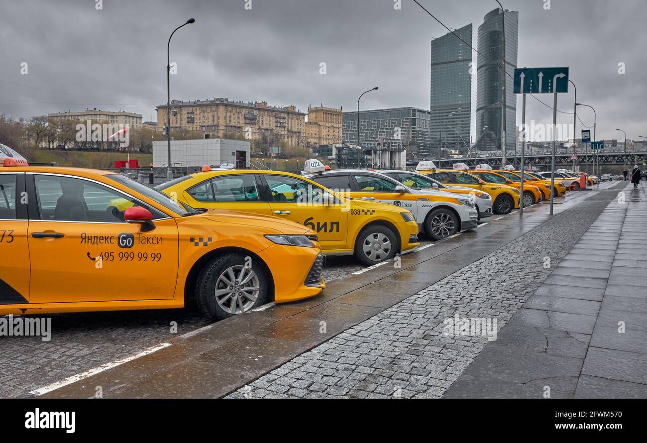 Row of taxi cars in the city center parking lot, city mobile transport: Moscow, Russia - April 21, 2021 Stock Photo