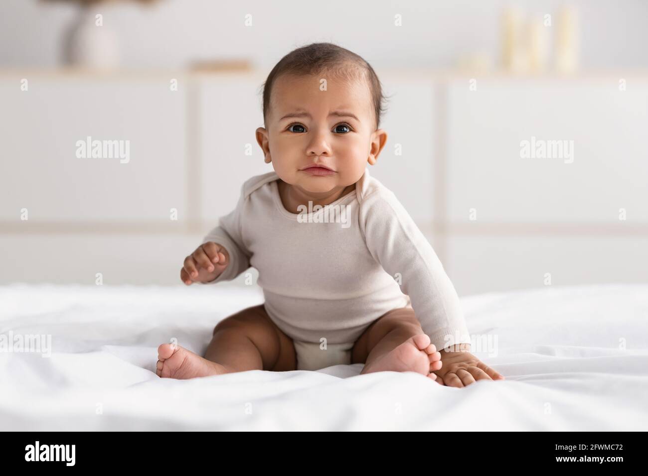 Portrait of sad African American baby crying alone Stock Photo