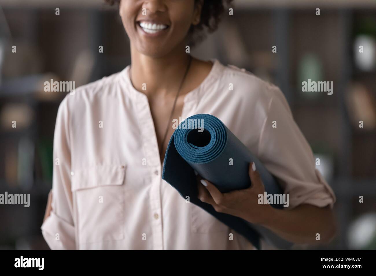 Fit woman on a mat at ocean. Slim female relaxing after yoga exercises  stock photo