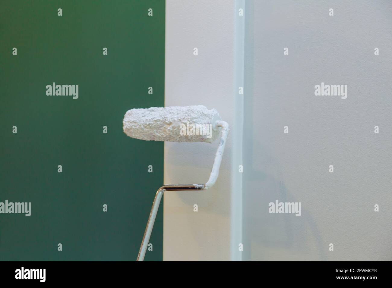 Contractor painter updating colors of painting doors molding trim using