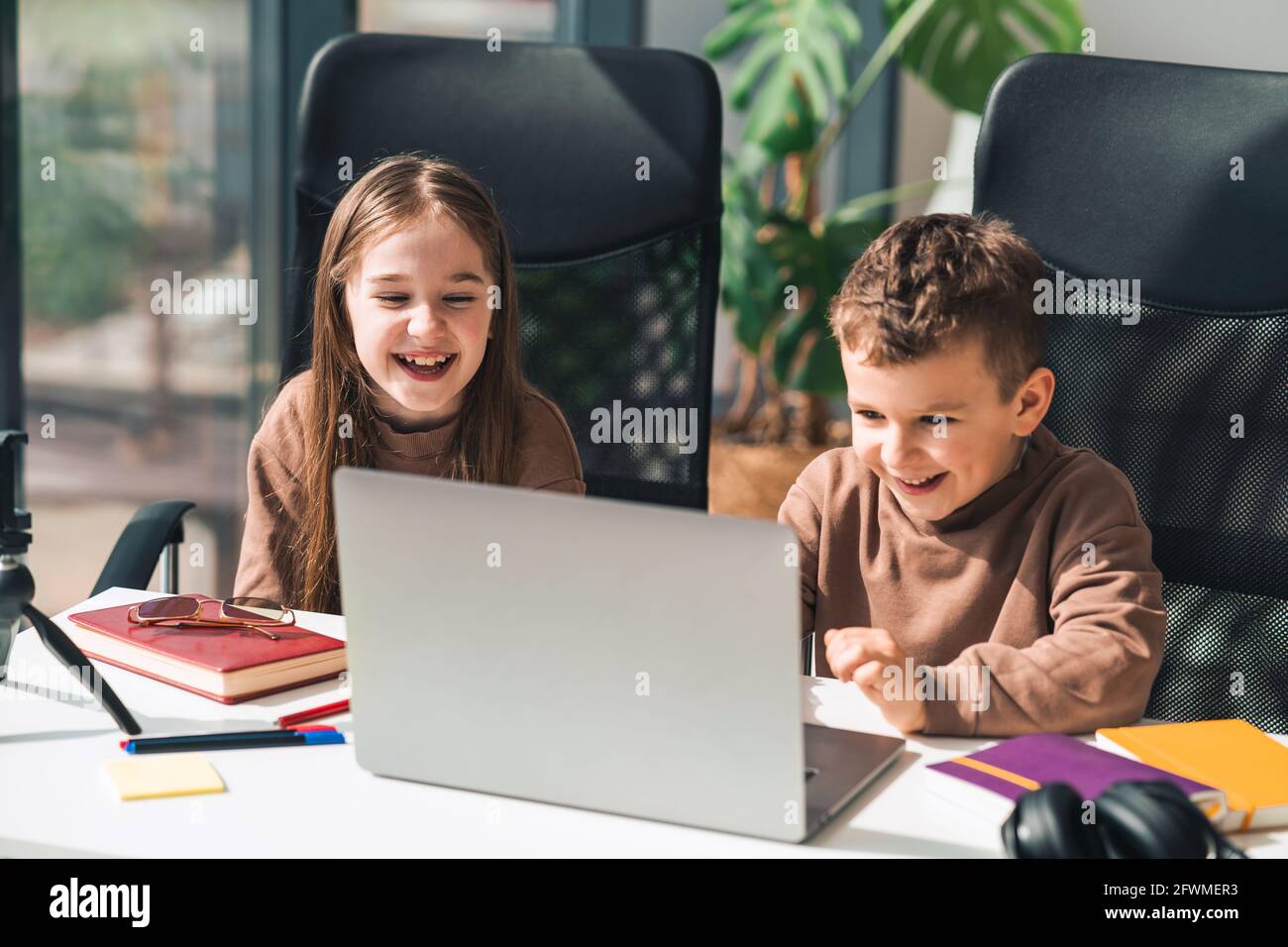 Smiling boy and girl study online in home at the laptop Stock Photo - Alamy