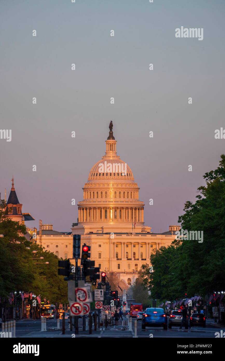 The last rays of the day shine on the United States Capitol Building in Washington, D.C., viewed from Pennsylvania Avenue. Stock Photo