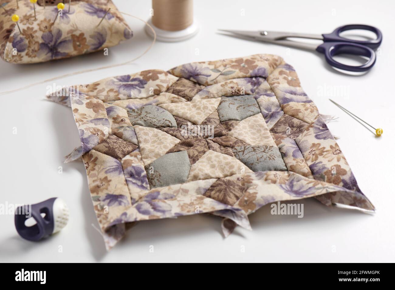 Patchwork block, pincushion, sewing and quilting accessories Stock Photo -  Alamy