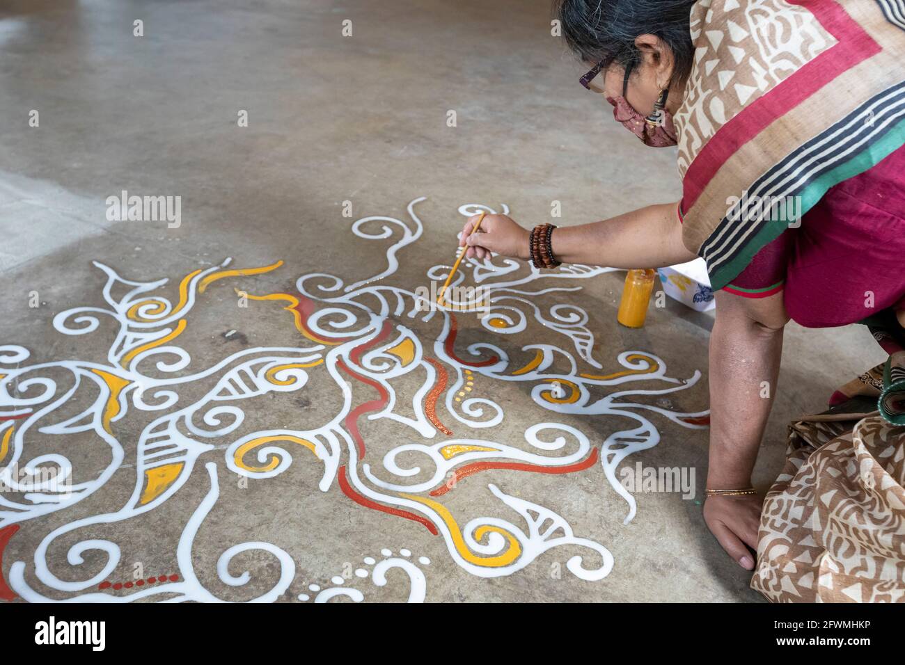 Hamtramck, Michigan - Boisali Biswas demonstrates the art of Alpona, ephemeral floor painting which is practiced in West Bengal in India and in Bangla Stock Photo