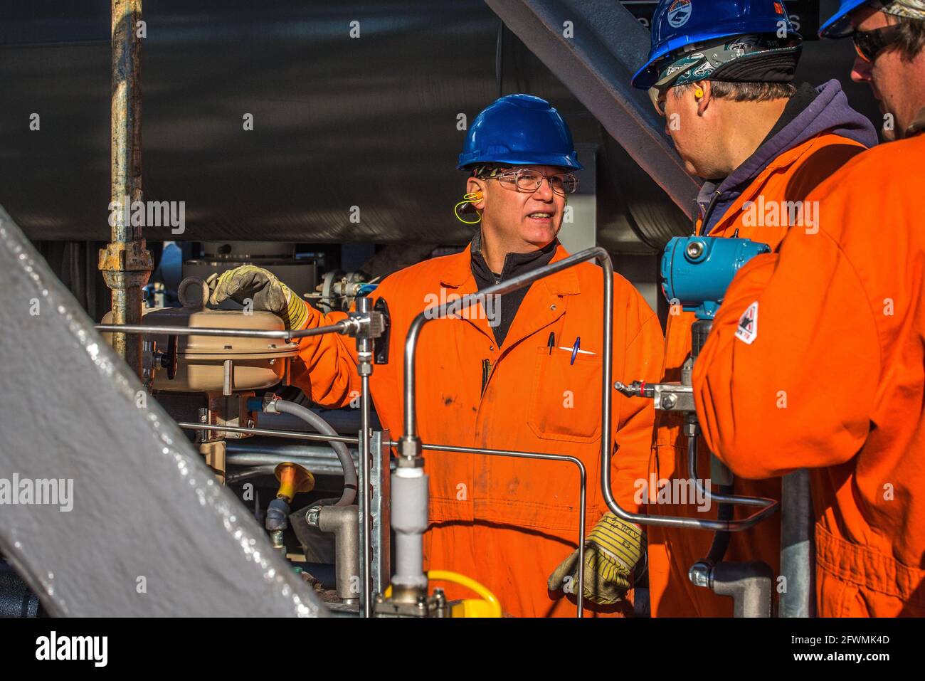 Oil refinery, industrial workers Stock Photo - Alamy