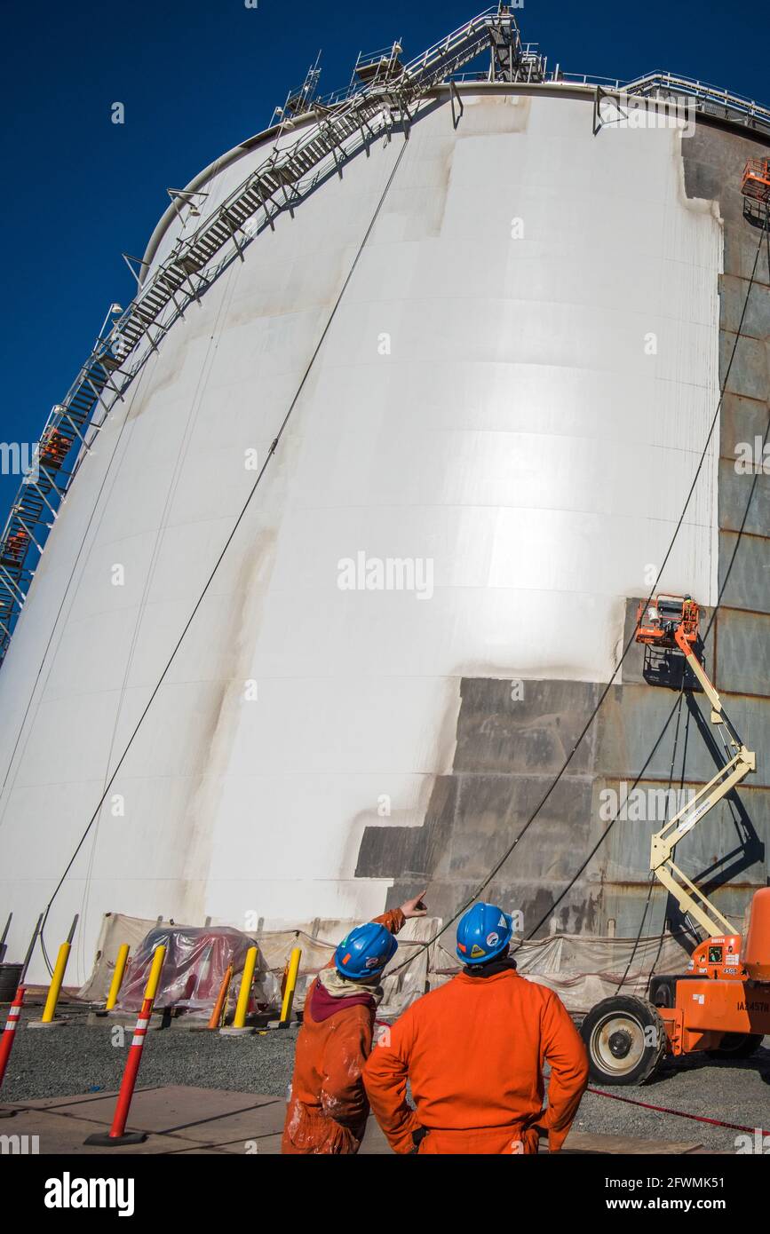 Oil refinery, industrial workers Stock Photo - Alamy