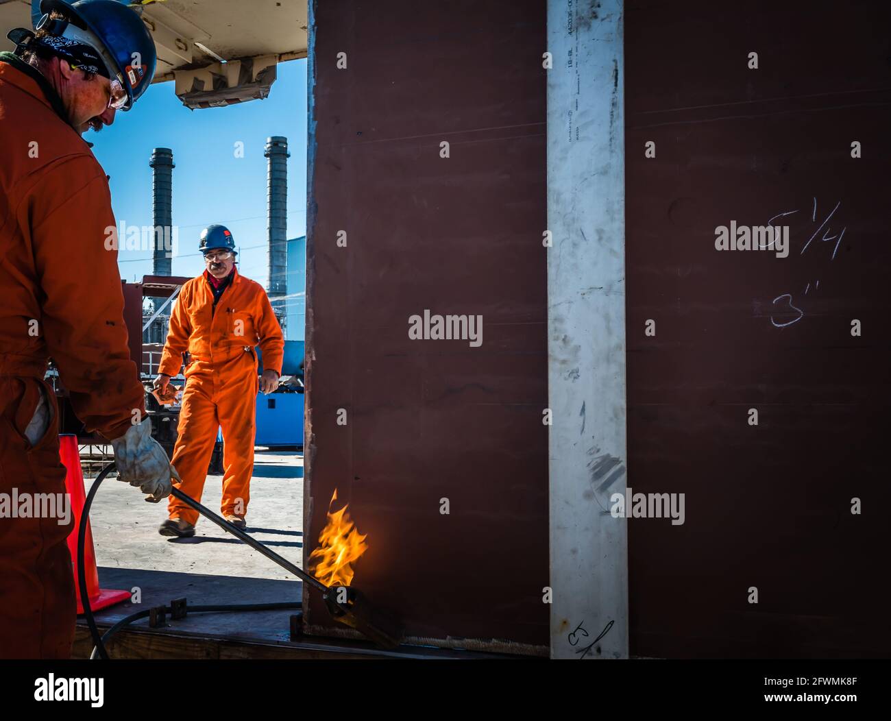 Oil refinery, industrial workers Stock Photo - Alamy