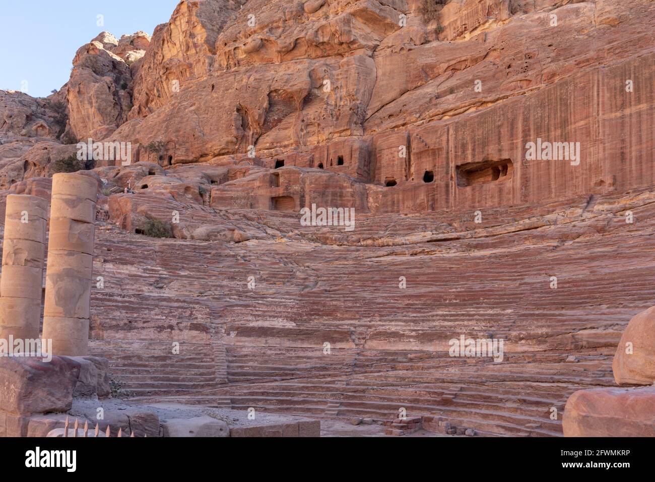 Ruins of the Petra Theatre carved and built at the foot of sand-stone rock formations by Nabataeans in the 1st century in the ancient city of Petra, J Stock Photo