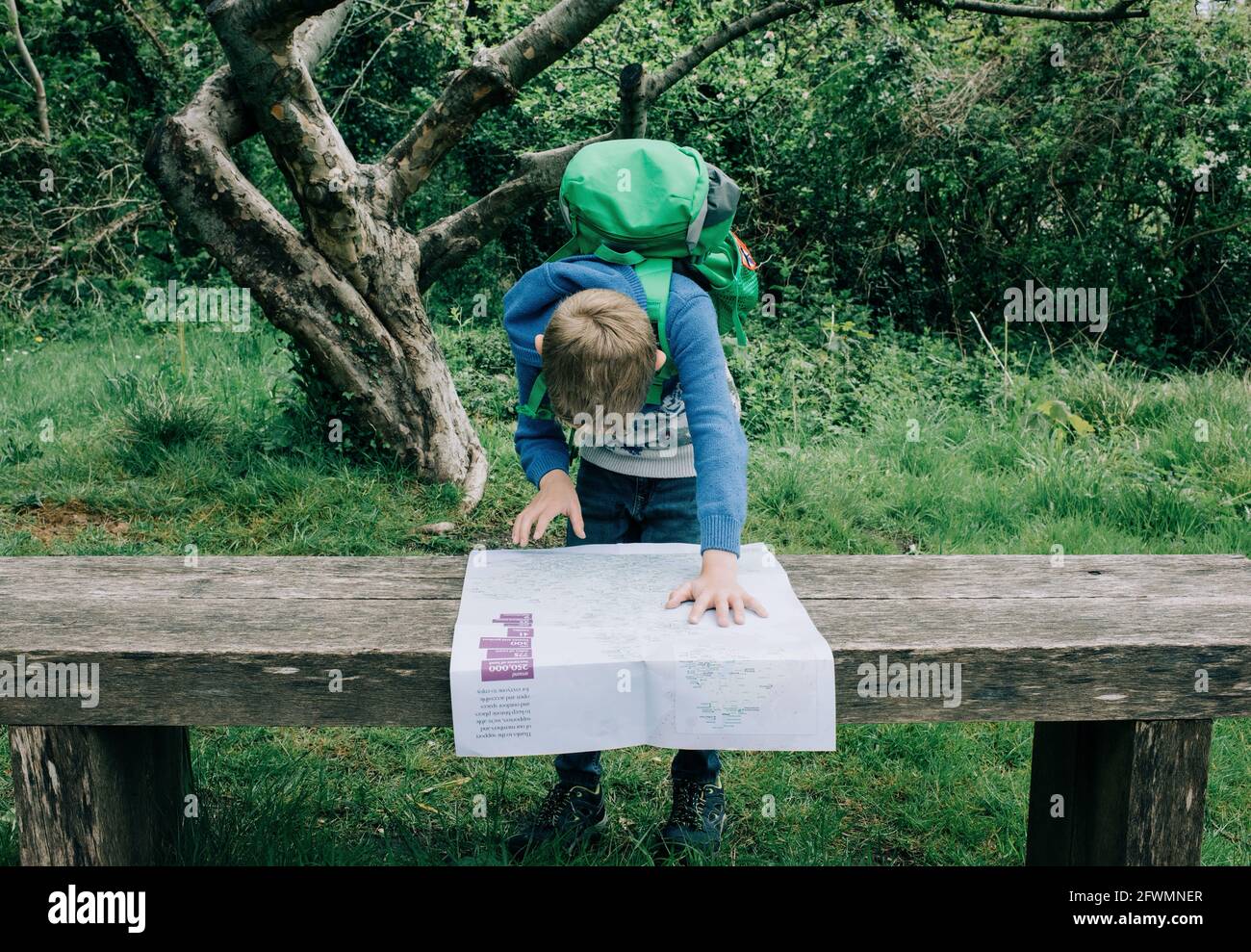boy looking at a map of the UK whilst exploring the countryside Stock ...