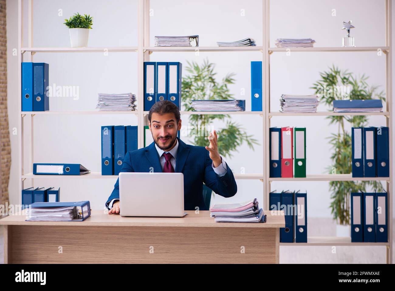 Young employee and too many work in the office Stock Photo - Alamy