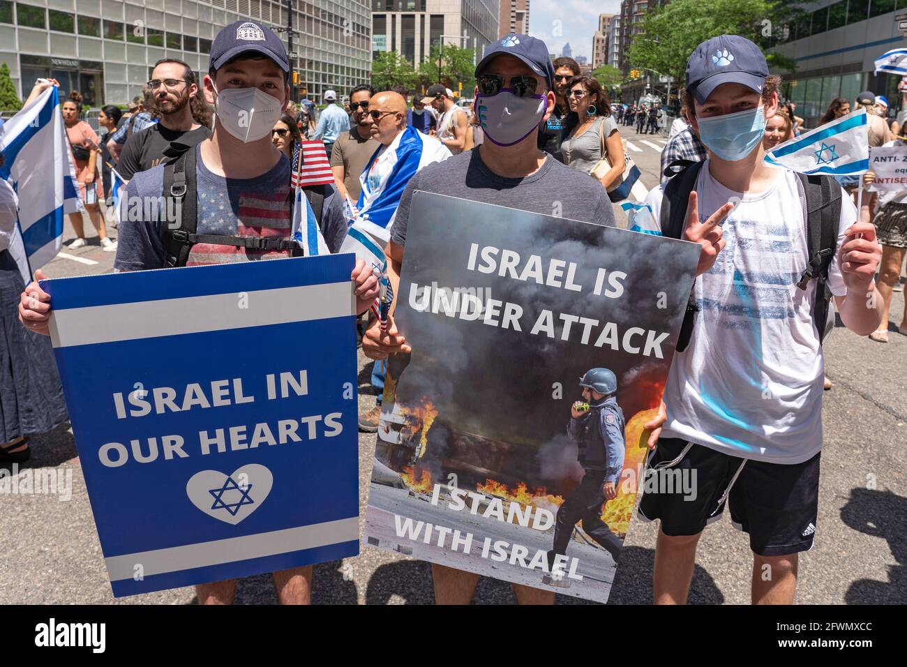 NEW YORK, NY - MAY 23: Pro-Israel supporters hold signs that reads 'Israel In Our Hearts' and 'Israel Is Under Attack I Stand With Israel' in downtown during a Rally In Support Of Israel and Against Antisemitism on May 23, 2021 in New York City.    Jewish and pro-Israel demonstrators gathered at the site of the World Trade Center, flying Israeli and American flags in solidarity with Israel following the most recent war with Hamas in Gaza, and in protest against rising levels of antisemitism and severe anti-Jewish attacks in the wake of the conflict. Credit: Ron Adar/Alamy Live News Stock Photo