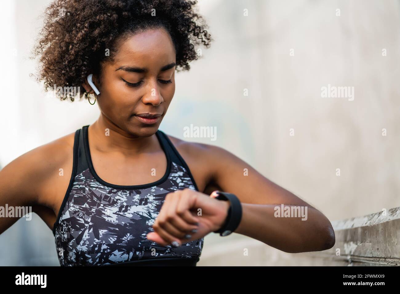 Fitness woman checking time on smart watch. Stock Photo
