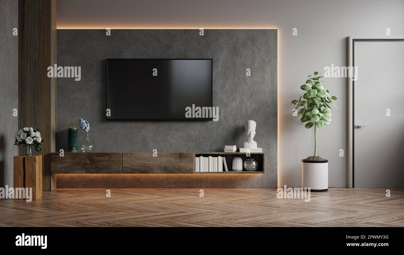 Mockup a TV wall mounted in a dark room with concrete wall.3d rendering