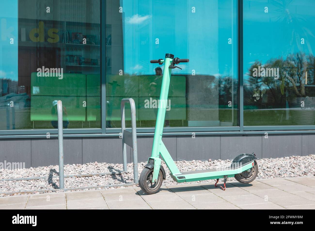 Scooter Rent Building rental electric scooter at city street near office building Stock Photo ...