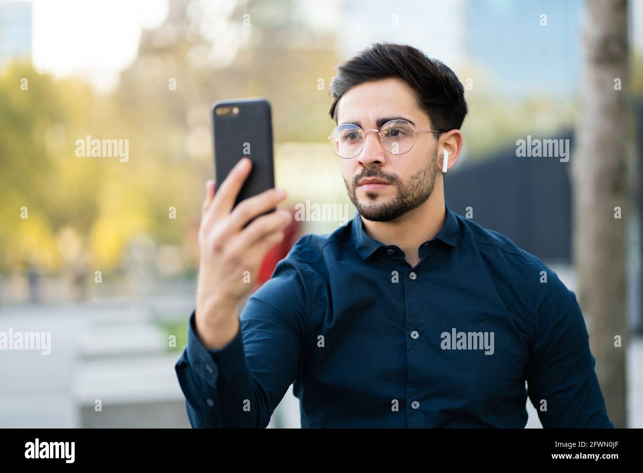 Young Man Using Face Id For Unlock Mobile Phone Outdoors Stock Photo Alamy