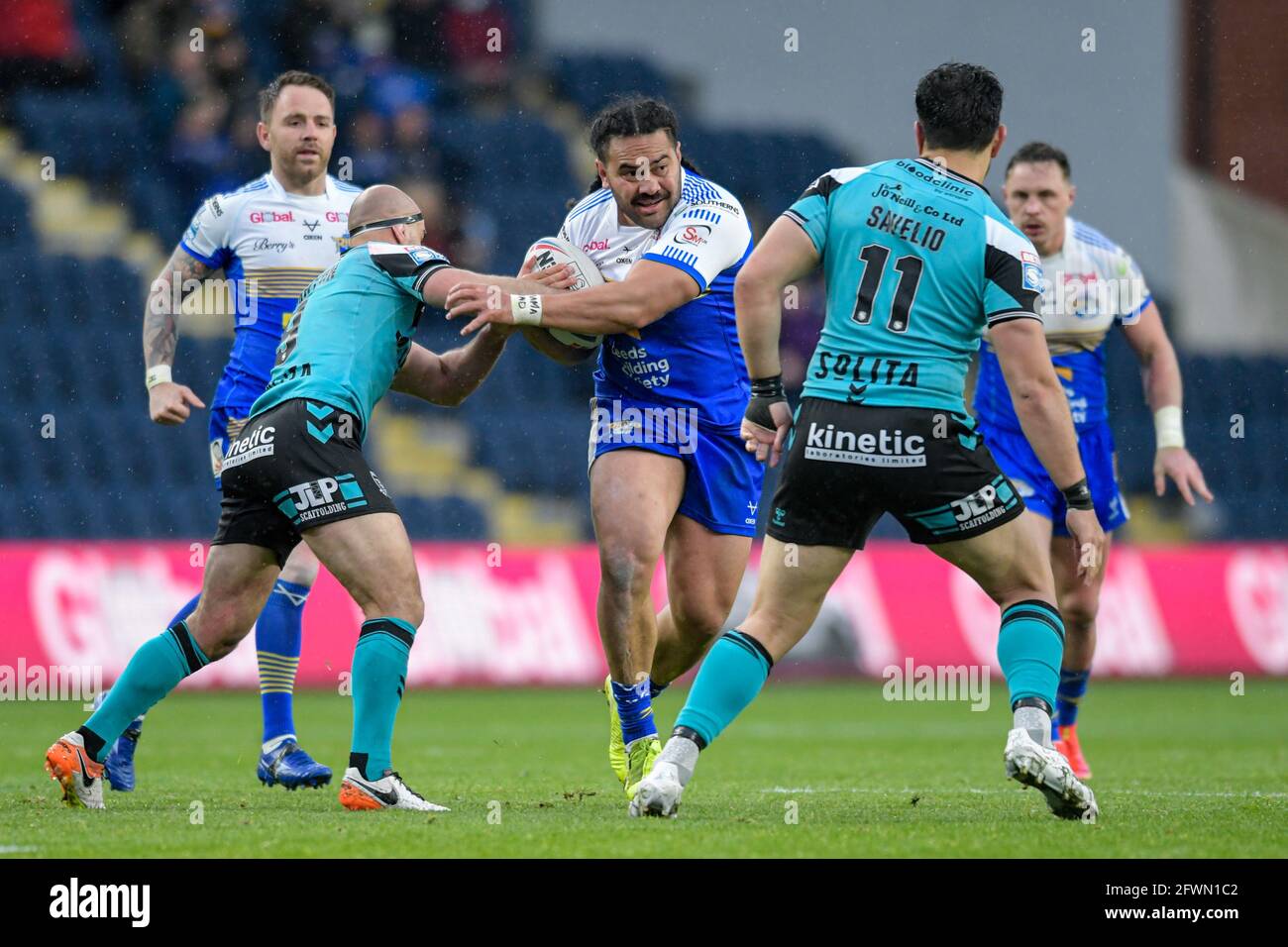 Konrad Hurrell (4) of Leeds Rhinos looks for a way past Danny Houghton ...