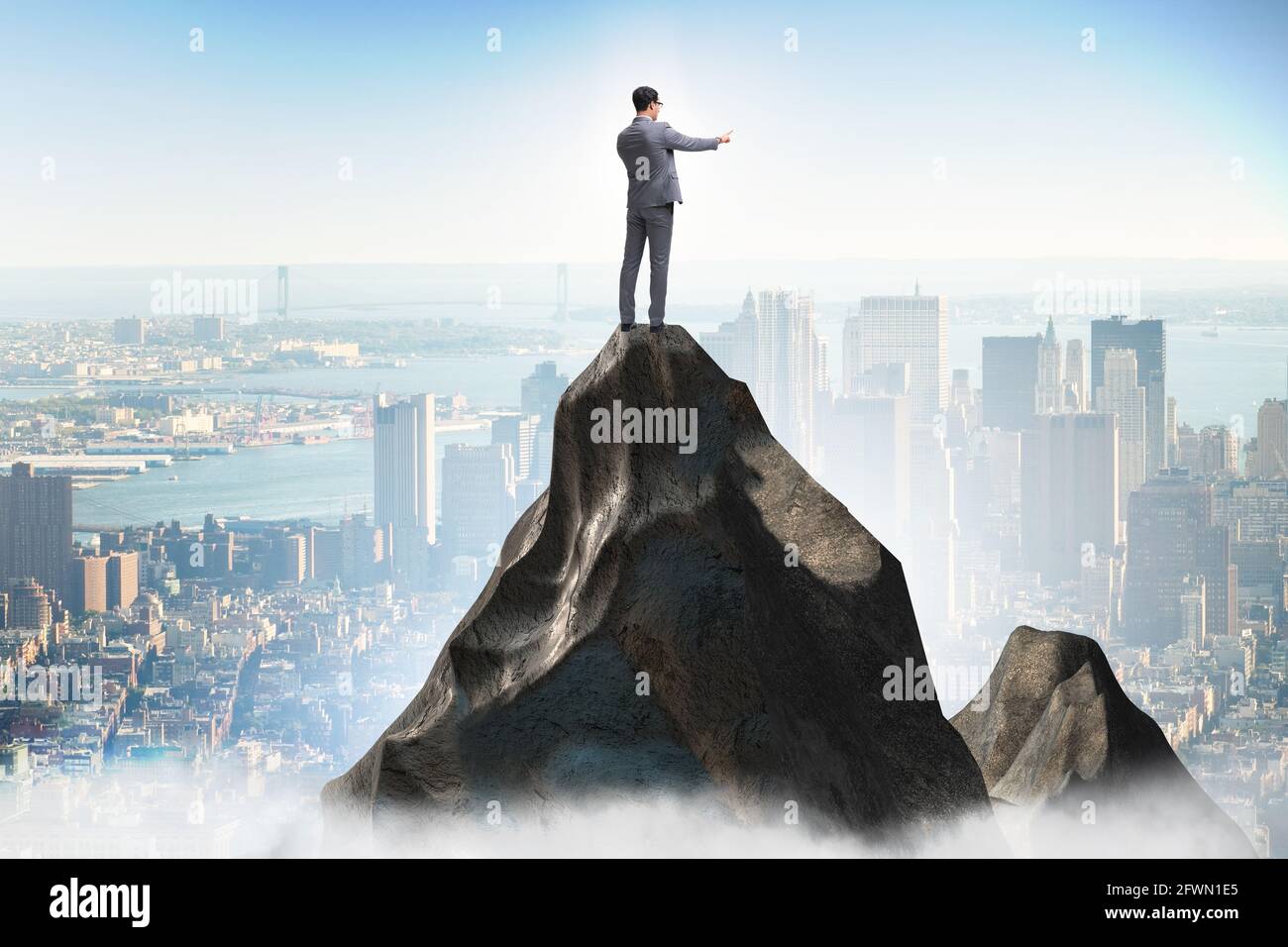Businessman at the top of mountain in the career concept Stock Photo ...