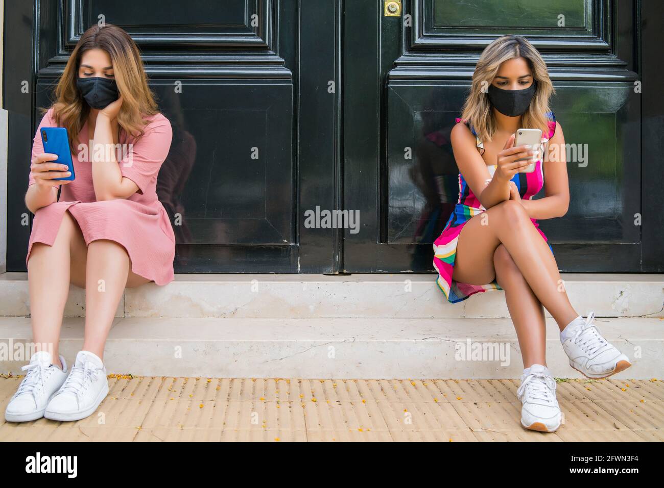 Two people wearing face mask and keeping distance outdoors Stock Photo ...