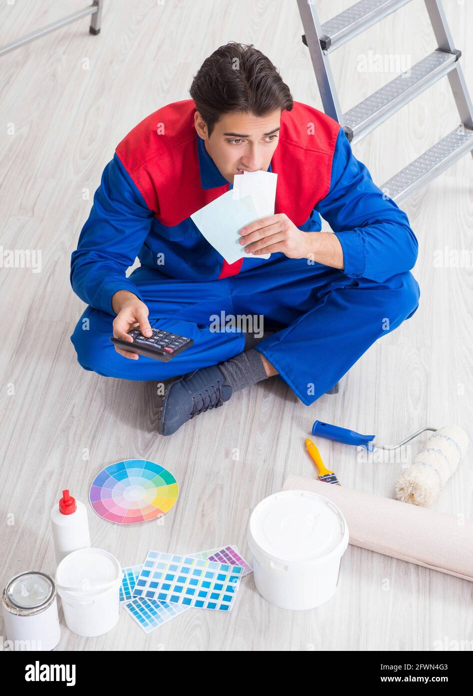 The young painter trying to match colours for painting job Stock Photo