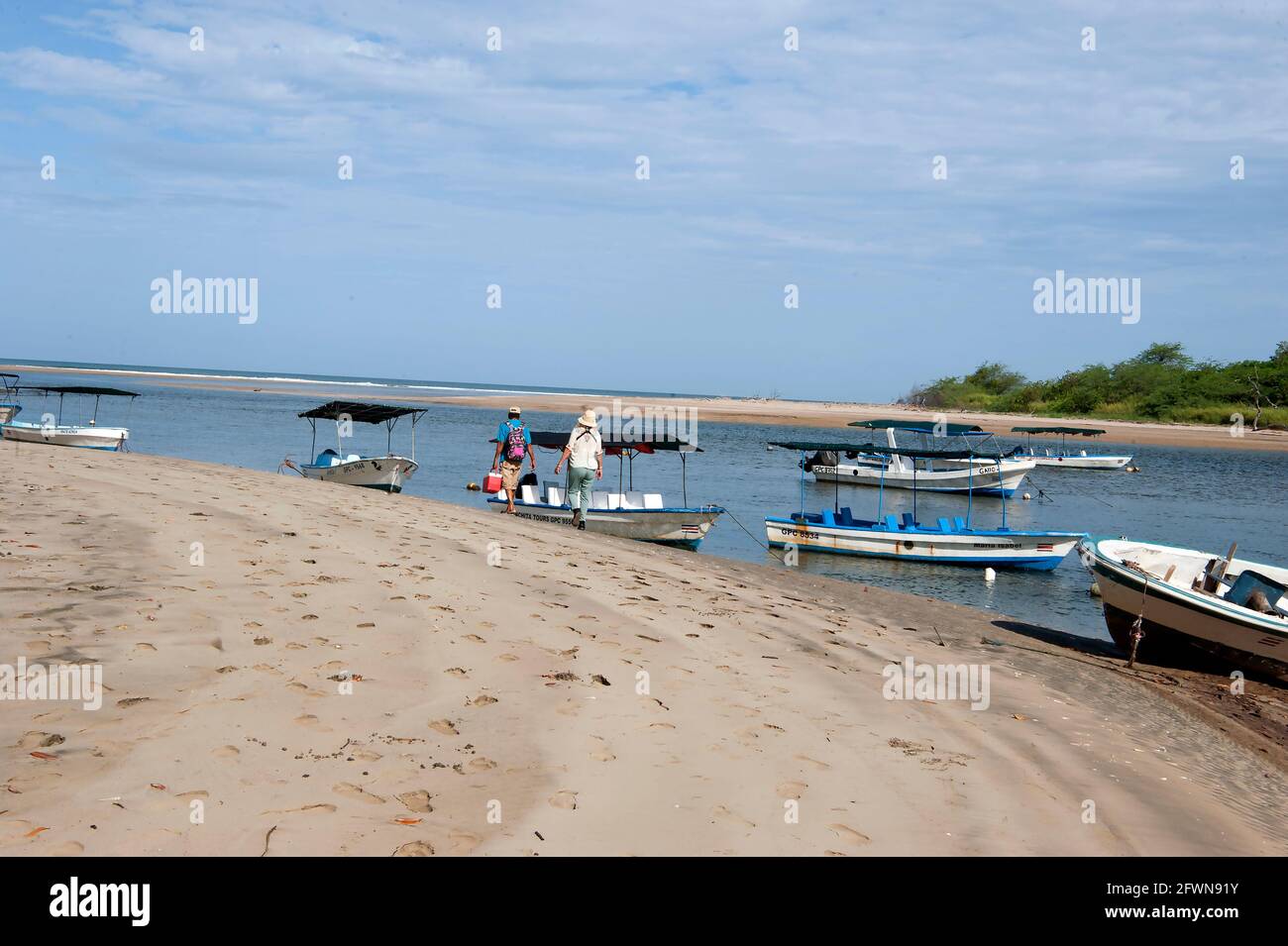 Tour boats at the mouth of a river in the National Park in Tamarindo, Costa Rica Stock Photo