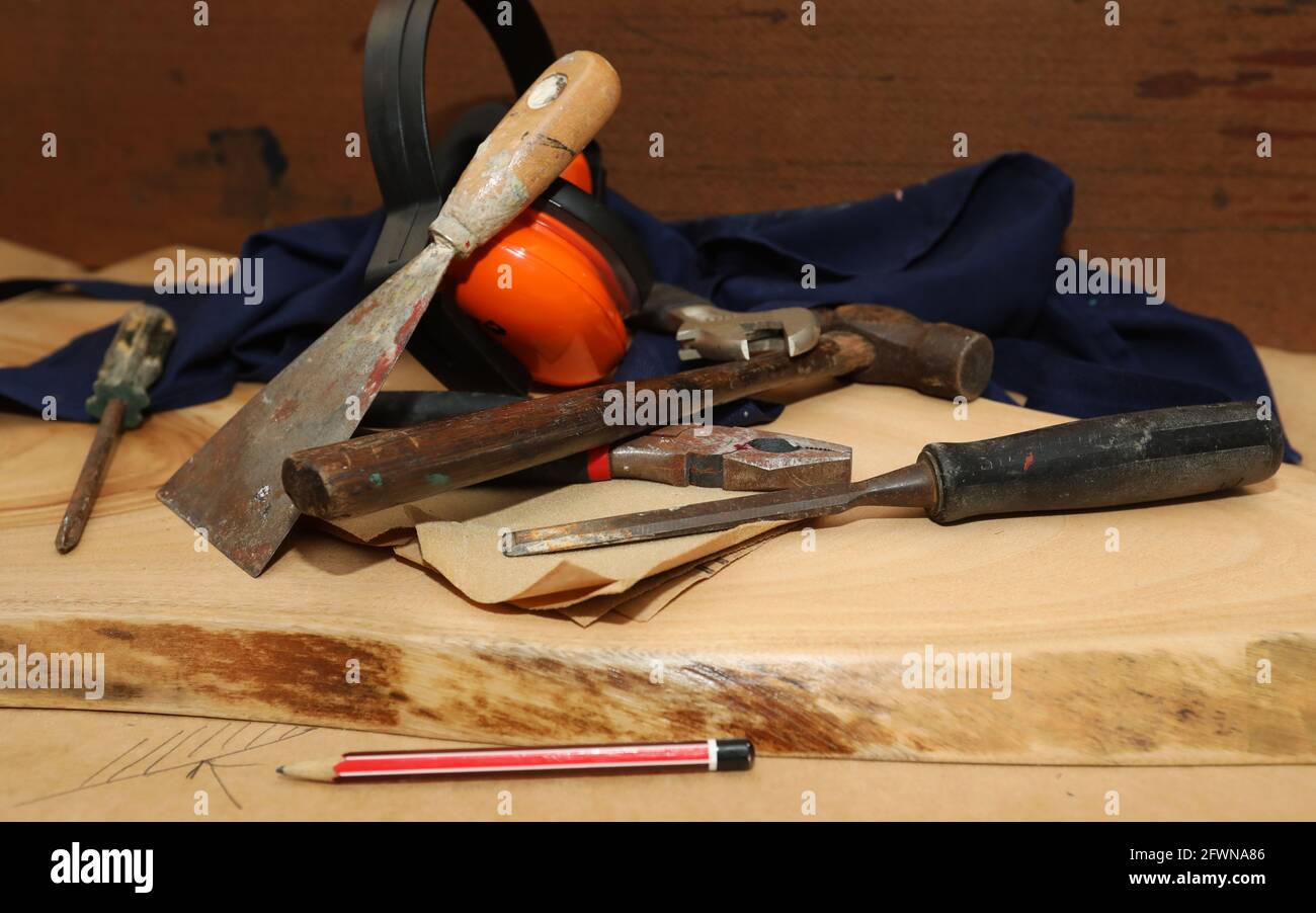 An arrangement of traditional manual building capentry or trade tools. Home handyman equipment on a sanded raw timber round. Stock Photo