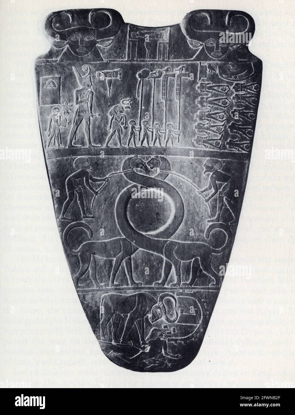 The slate palette of Narmer.At the top,flanked by two Hathor heads,the