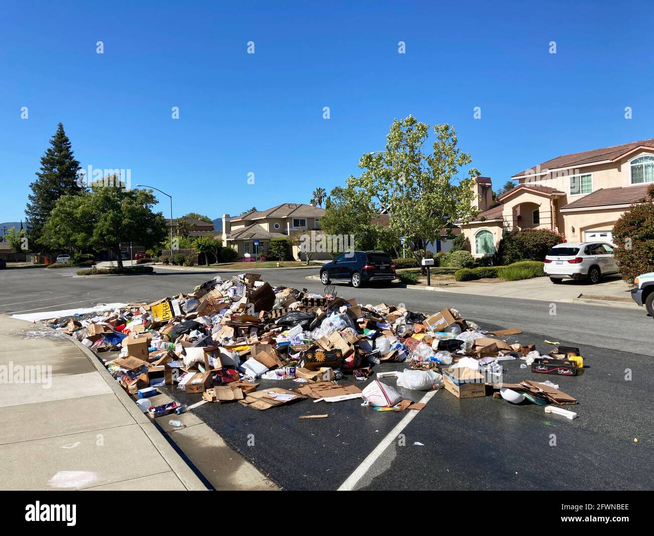 Wet pile of garbage on the street in residential neighborhood after