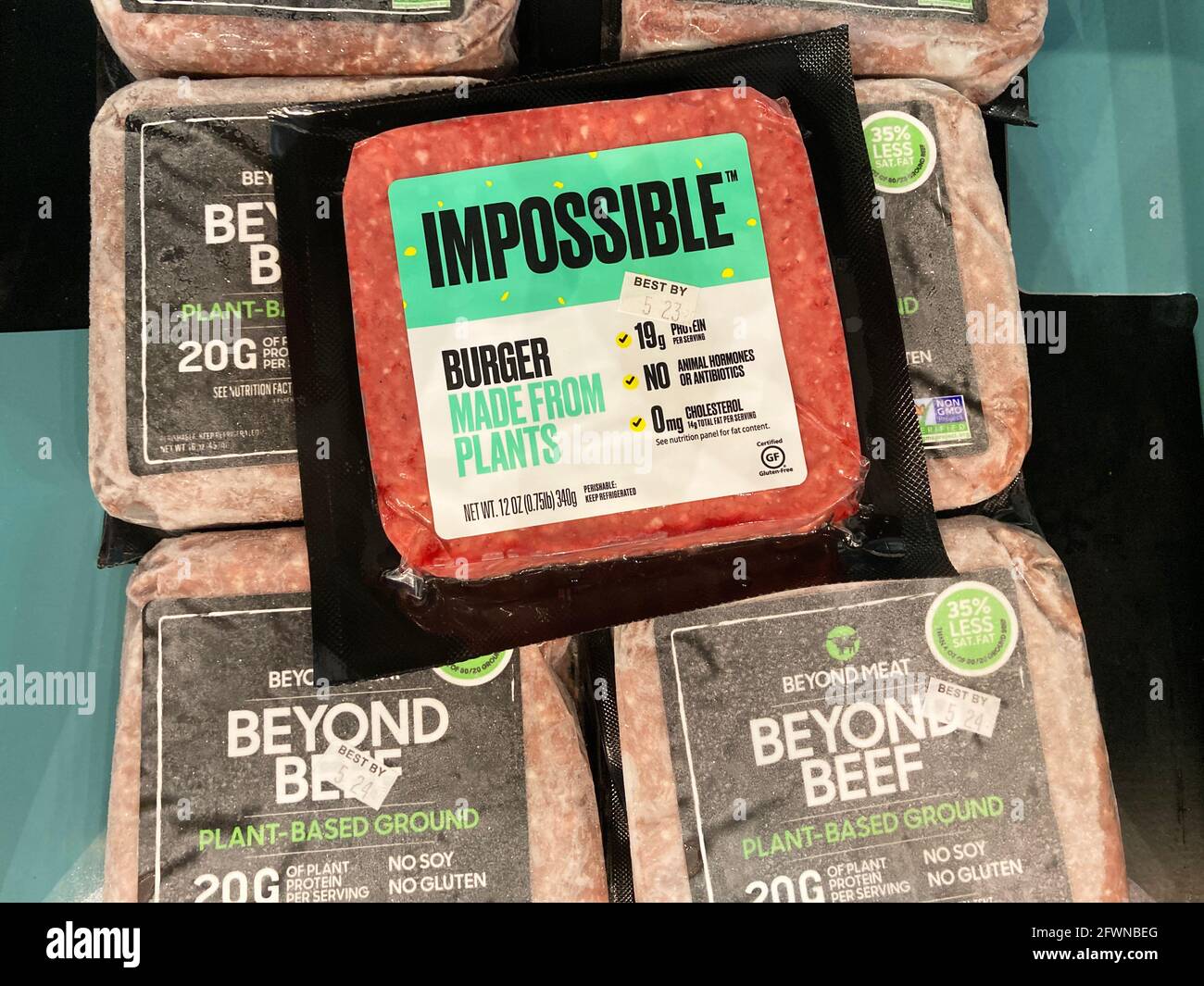 Impossible Foods Burger Made From Plants on top of Beyond Meat Beyond Beef Plant Based Ground Beef packages. - San Jose, California, USA - 2021 Stock Photo
