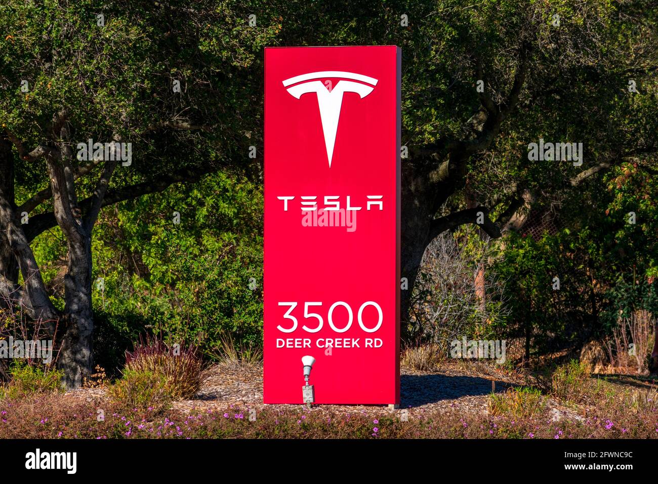 Tesla signpost with logo, sign at worldwide headquarters. Tesla, Inc