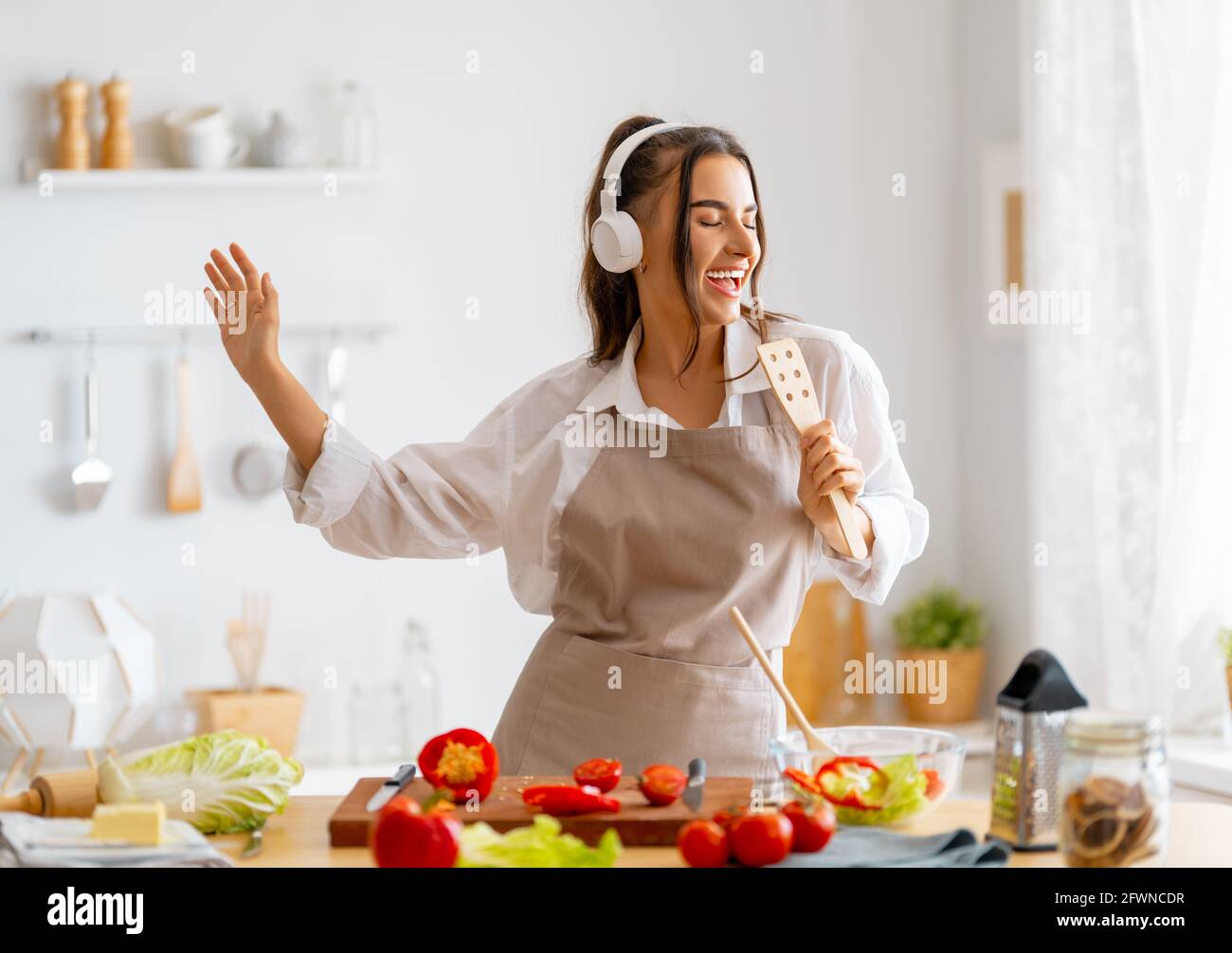 Healthy food at home. Woman is preparing the proper meal in the kitchen. Stock Photo