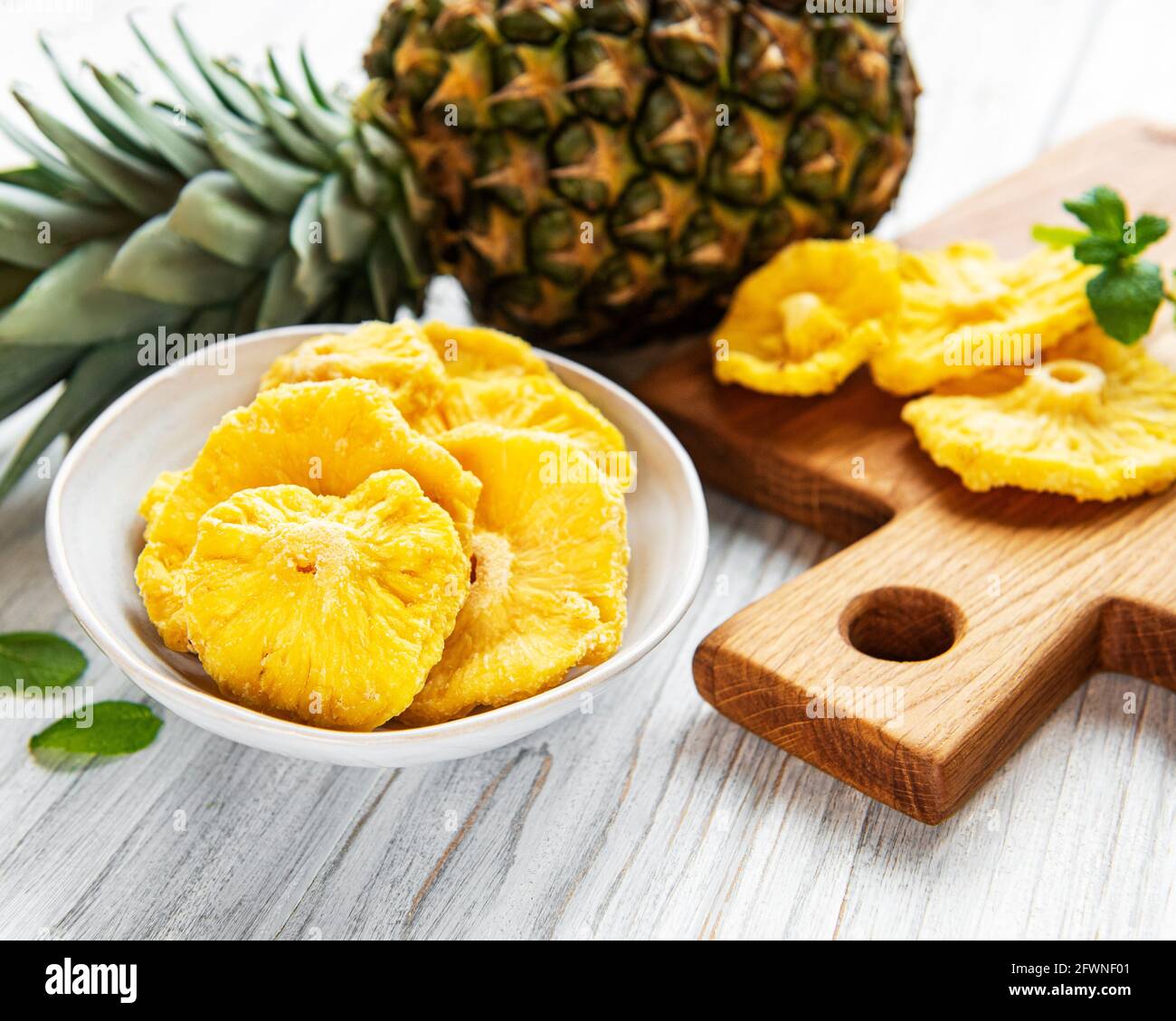 Pineapple dried rings on rustic wooden background Stock Photo