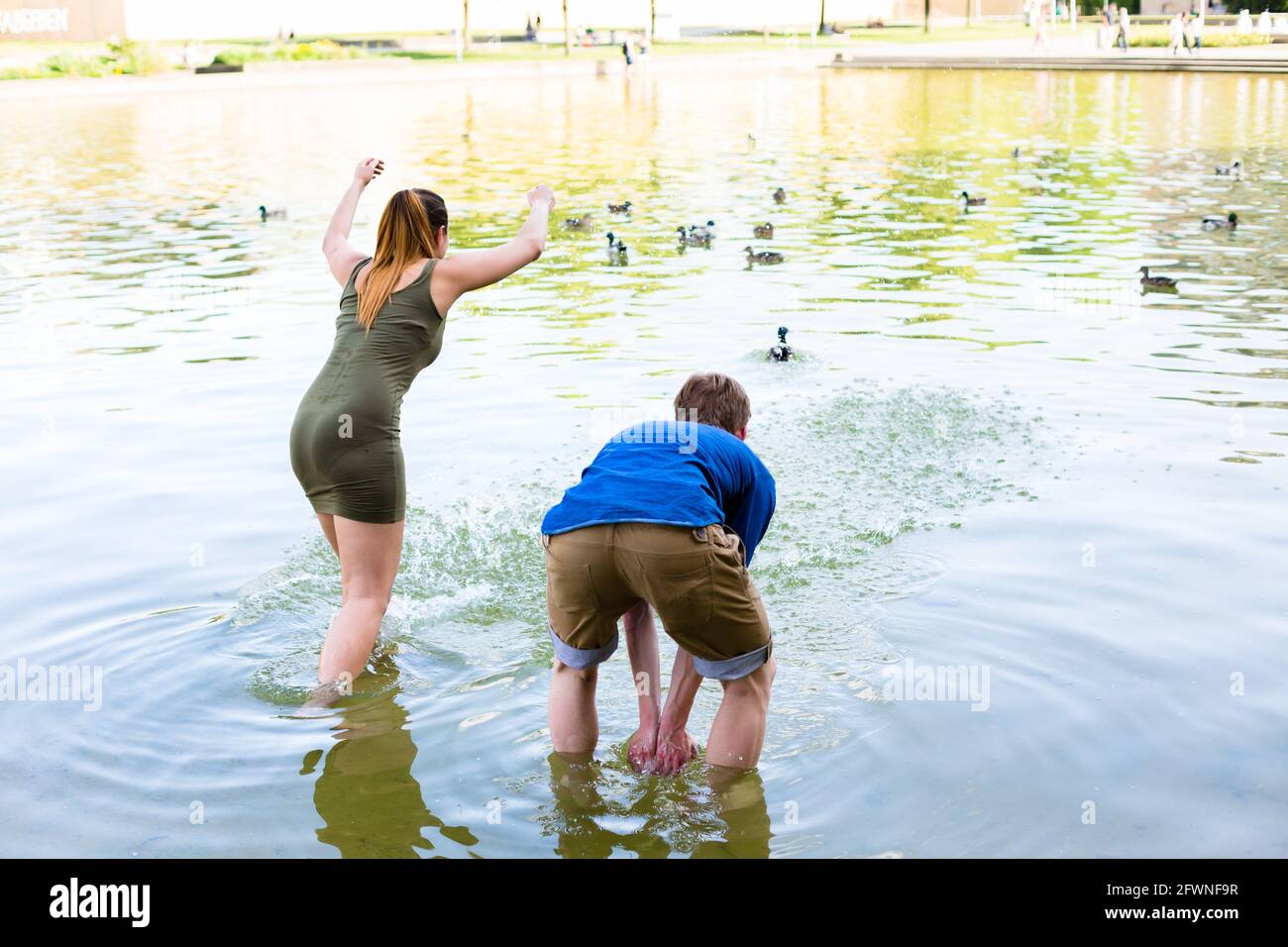 Couple romping cheerful in lake water Stock Photo