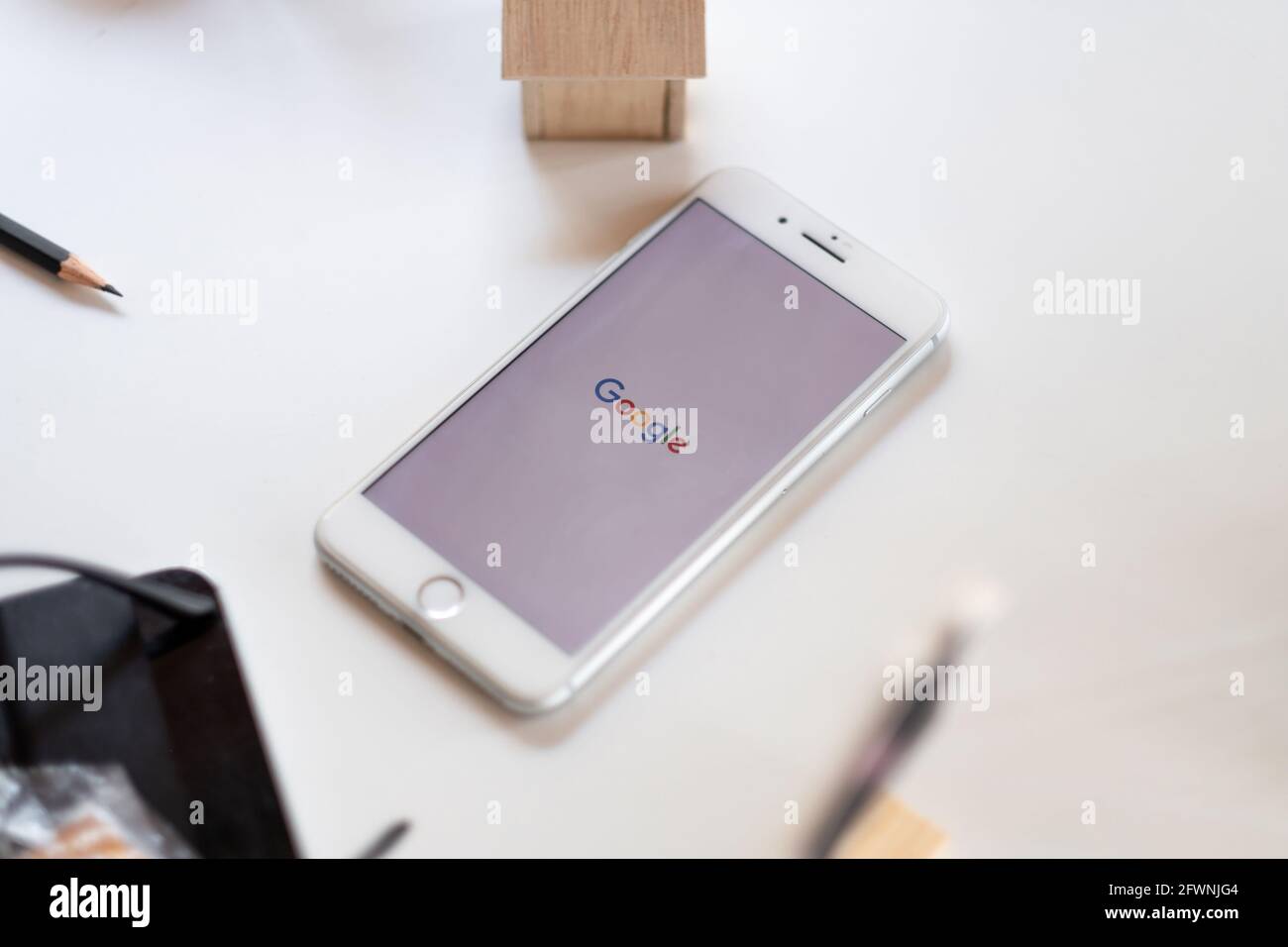 CHIANG MAI,THAILAND-MAY 16, 2021 Close-up image of smartphone with Google app on iPhone is an online social networking is popular In year Stock Photo
