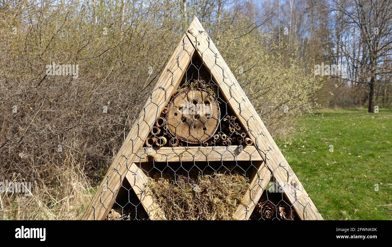Insect hotel. Wooden structure filled with natural material ready to ...