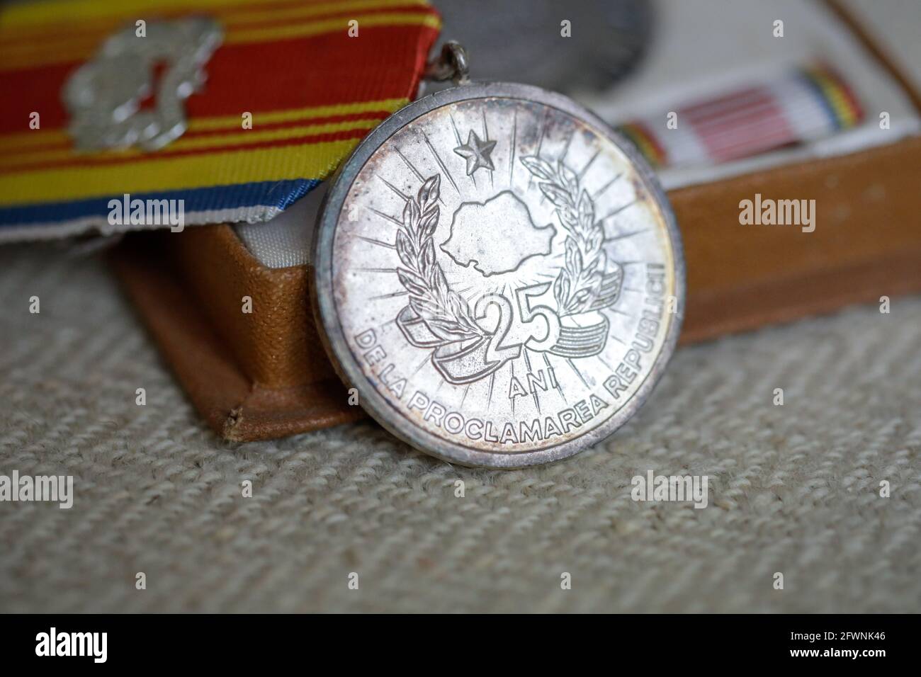 Marghia, Romania - May 5, 2021: Shallow depth of field (selective focus) details with old Communist award medal. Stock Photo