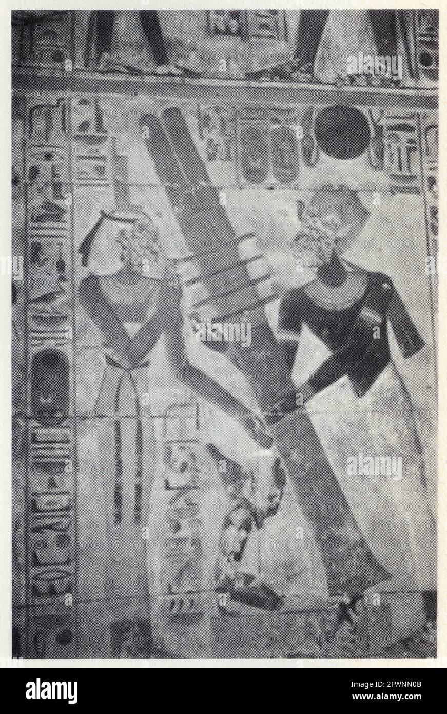 Wall relief in the temple of Seti I at Abydos showing Seti raising the Djed-pillar resurrecting the god Osiris, with the assistance of Isis Stock Photo