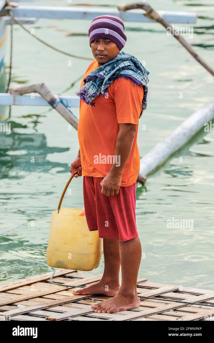 Fisherman in beanie hat at the busy fishing harbour & boatyard in this  southern resort town; Tanjung Bira, South Sulawesi, Indonesia Stock Photo -  Alamy