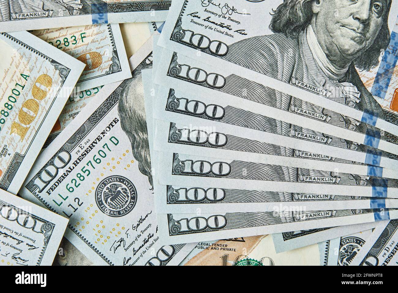 Dollar bills background. Pile of american money cash. One hundred usd dollars banknotes. Stock Photo