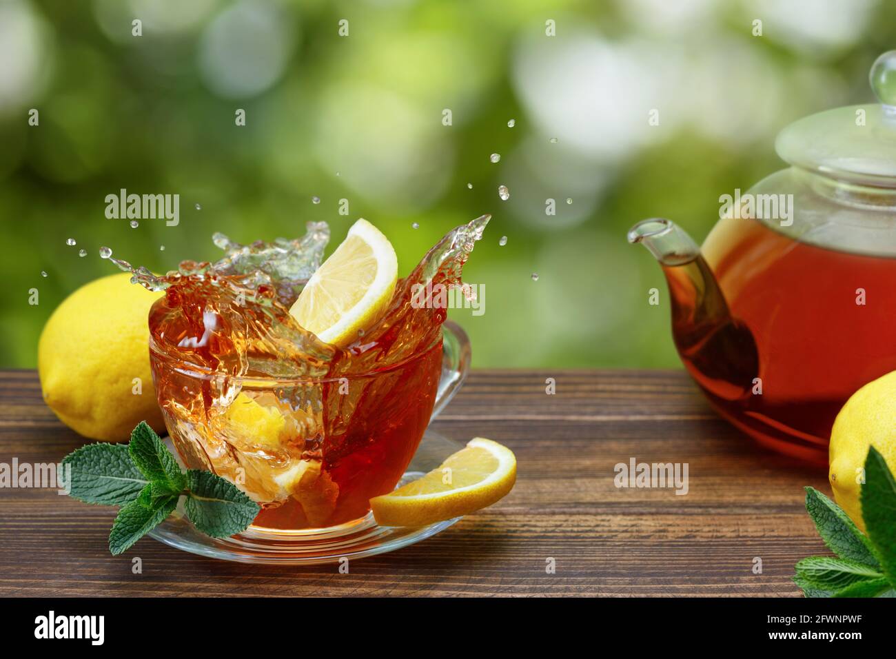 ice tea with slice of lemon in plastic cup on the wooden background Stock  Photo - Alamy