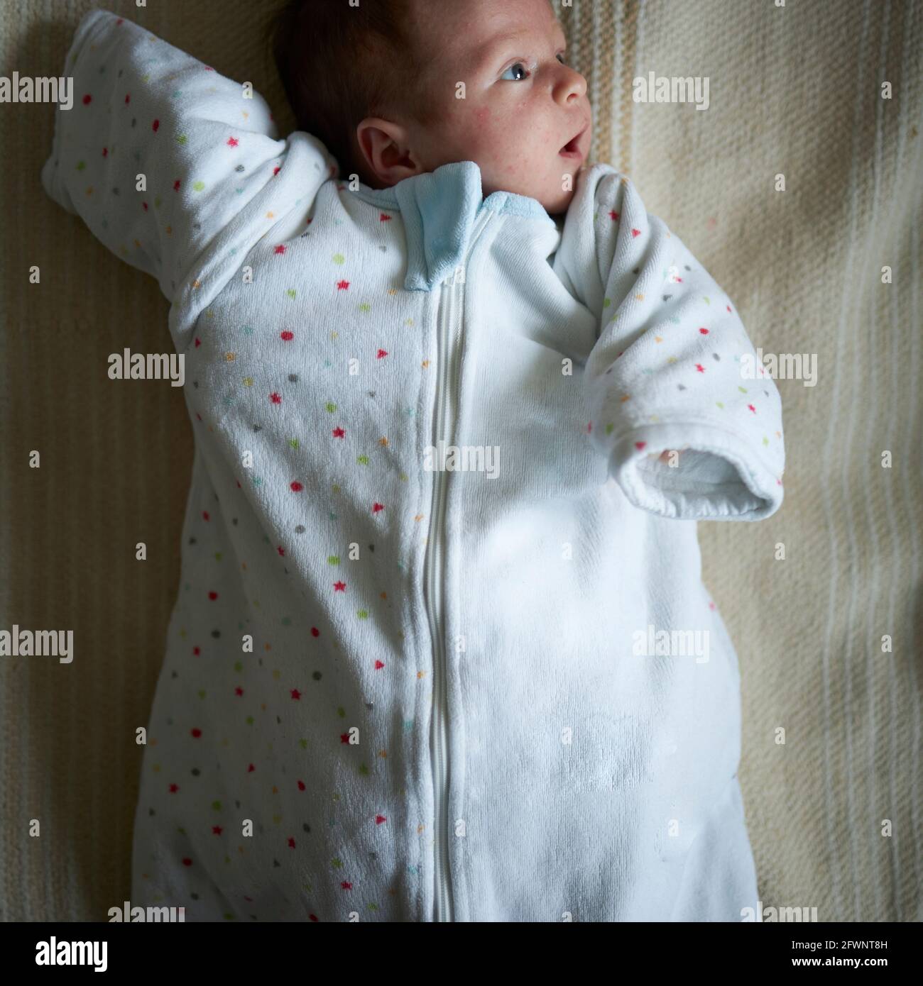 Playful baby in a oversized clothes Stock Photo
