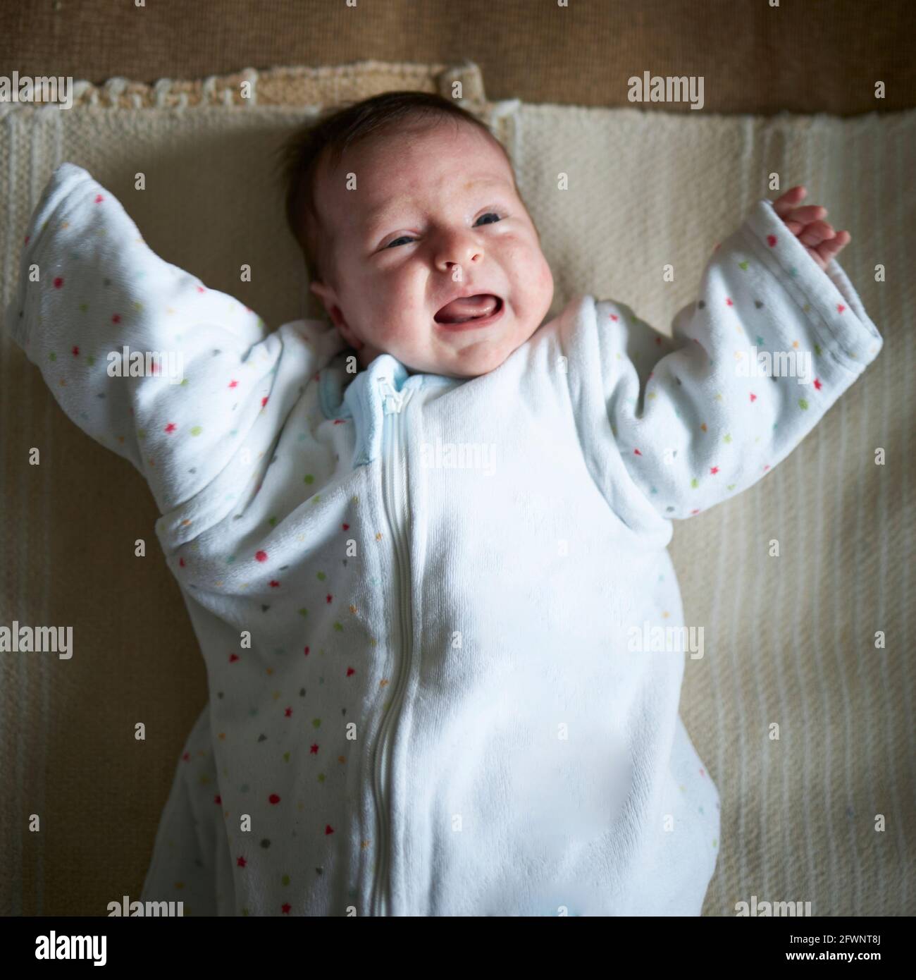 Crying baby in a oversized clothes Stock Photo