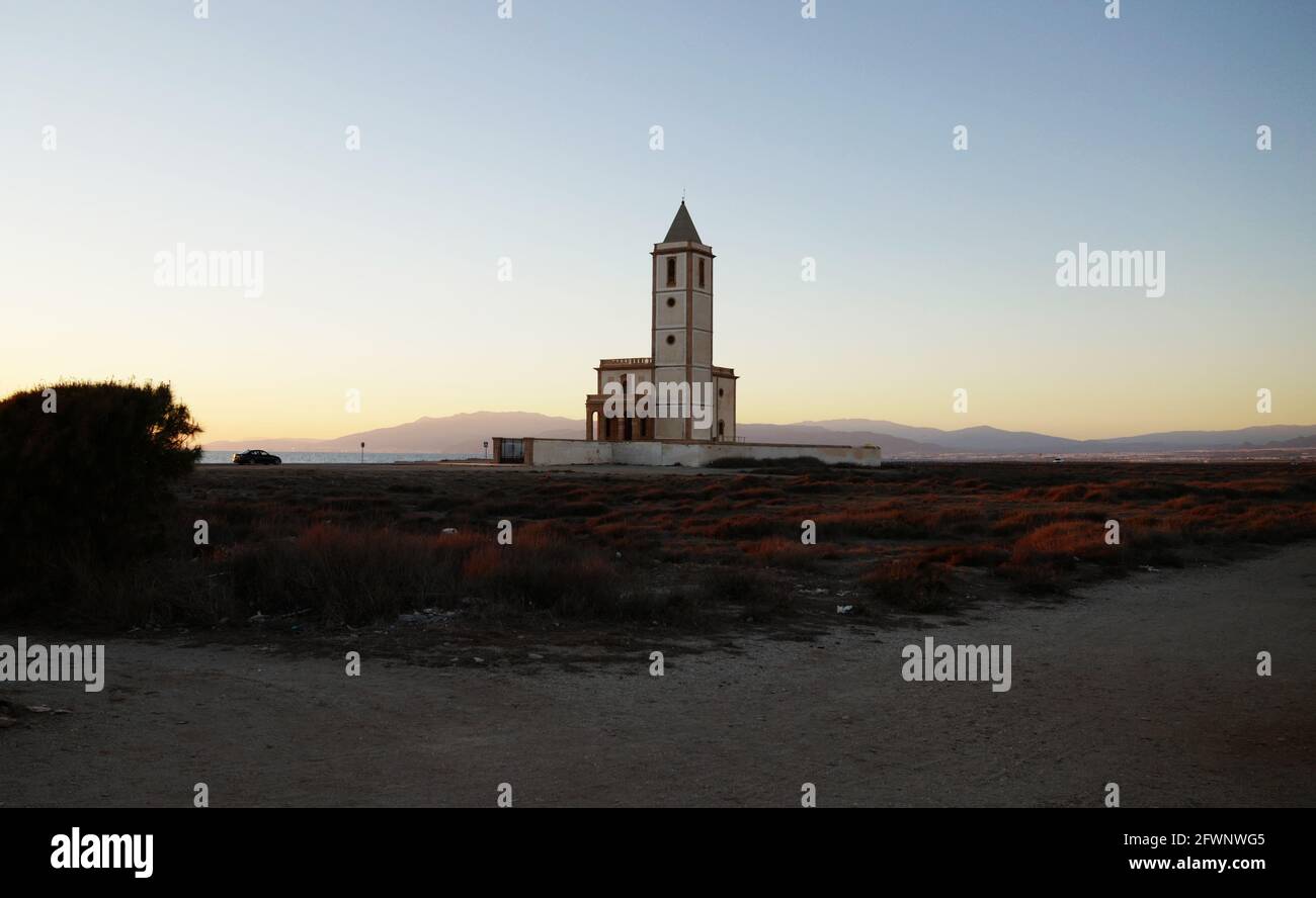 Sunset at Las Salinas, Cabo de Gata nature park, Almeria, south of Spain, with church tower. Stock Photo