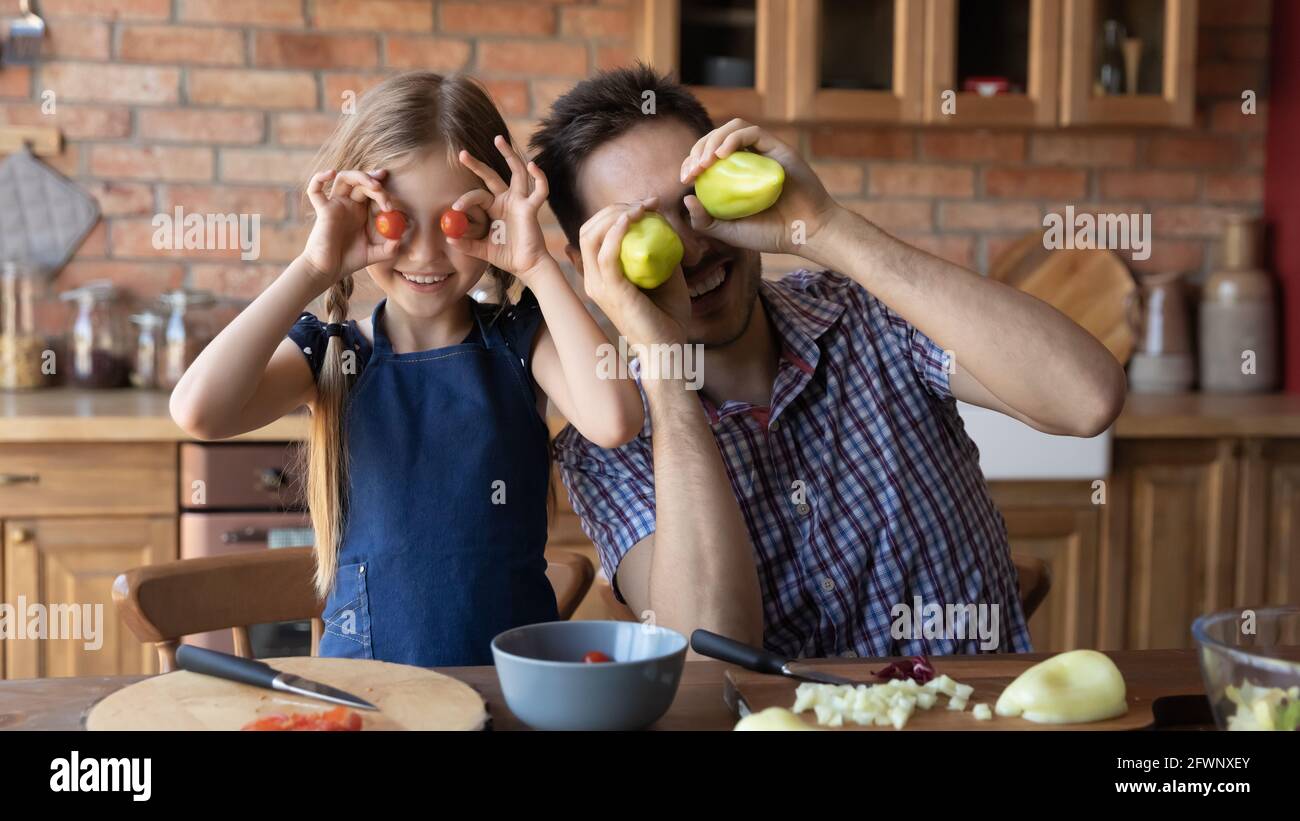 Happy dad and little daughter cooking dinner Stock Photo