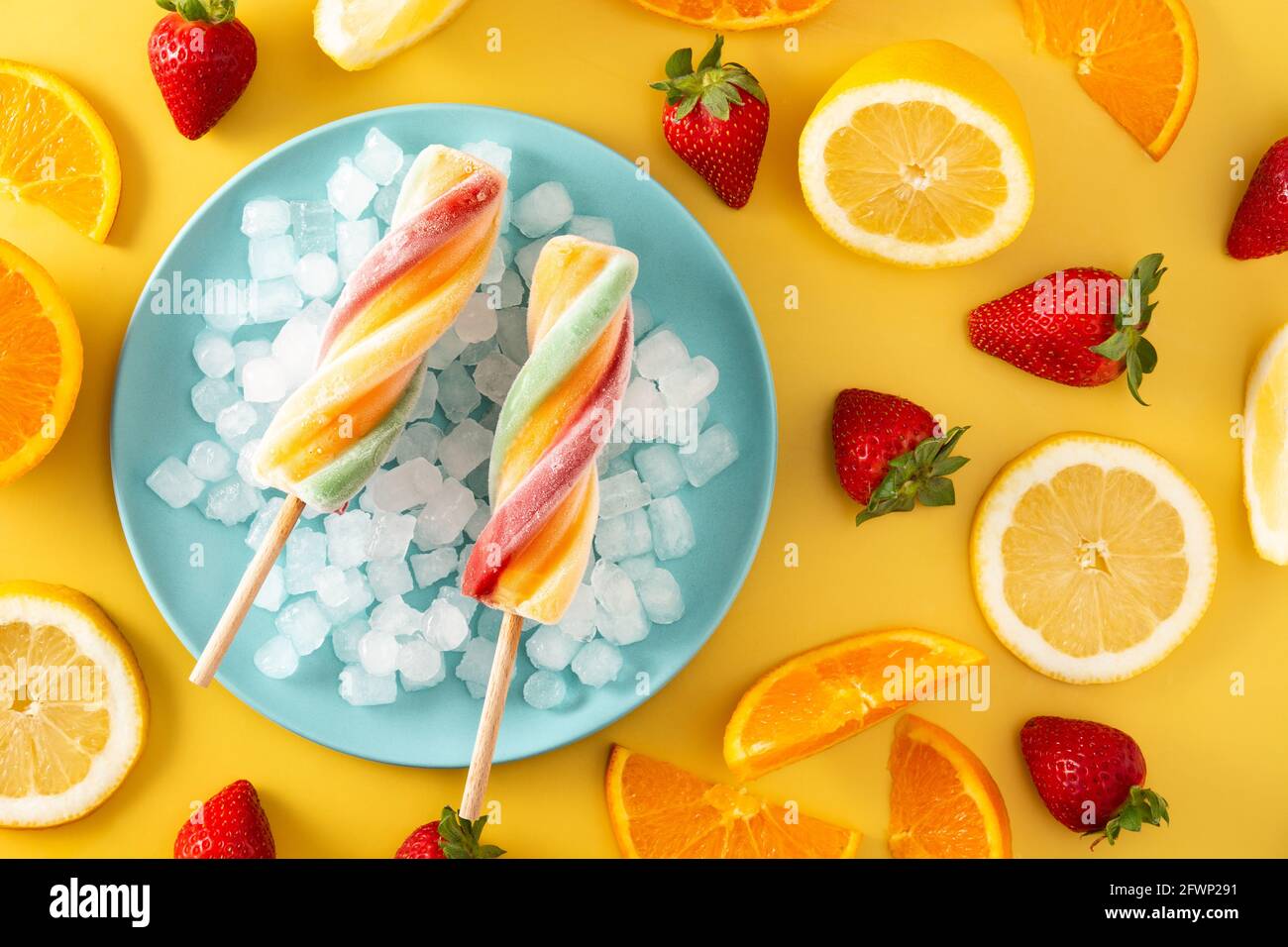 Spiral colorful popsicle on yellow background Stock Photo