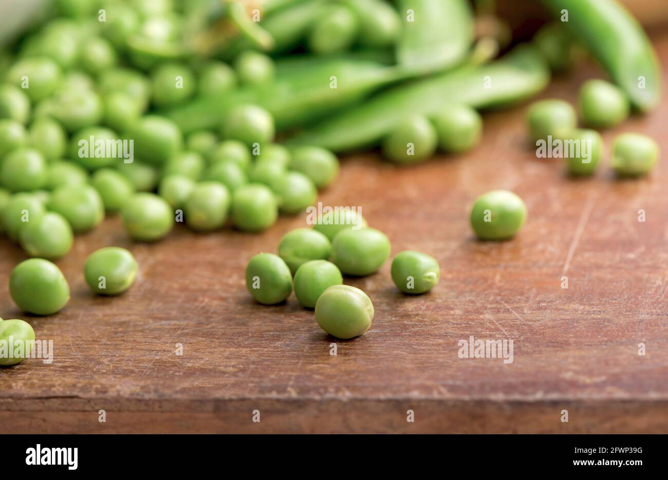 Green pea on rustic wooden background with copy space, natural wooden table. Stock Photo