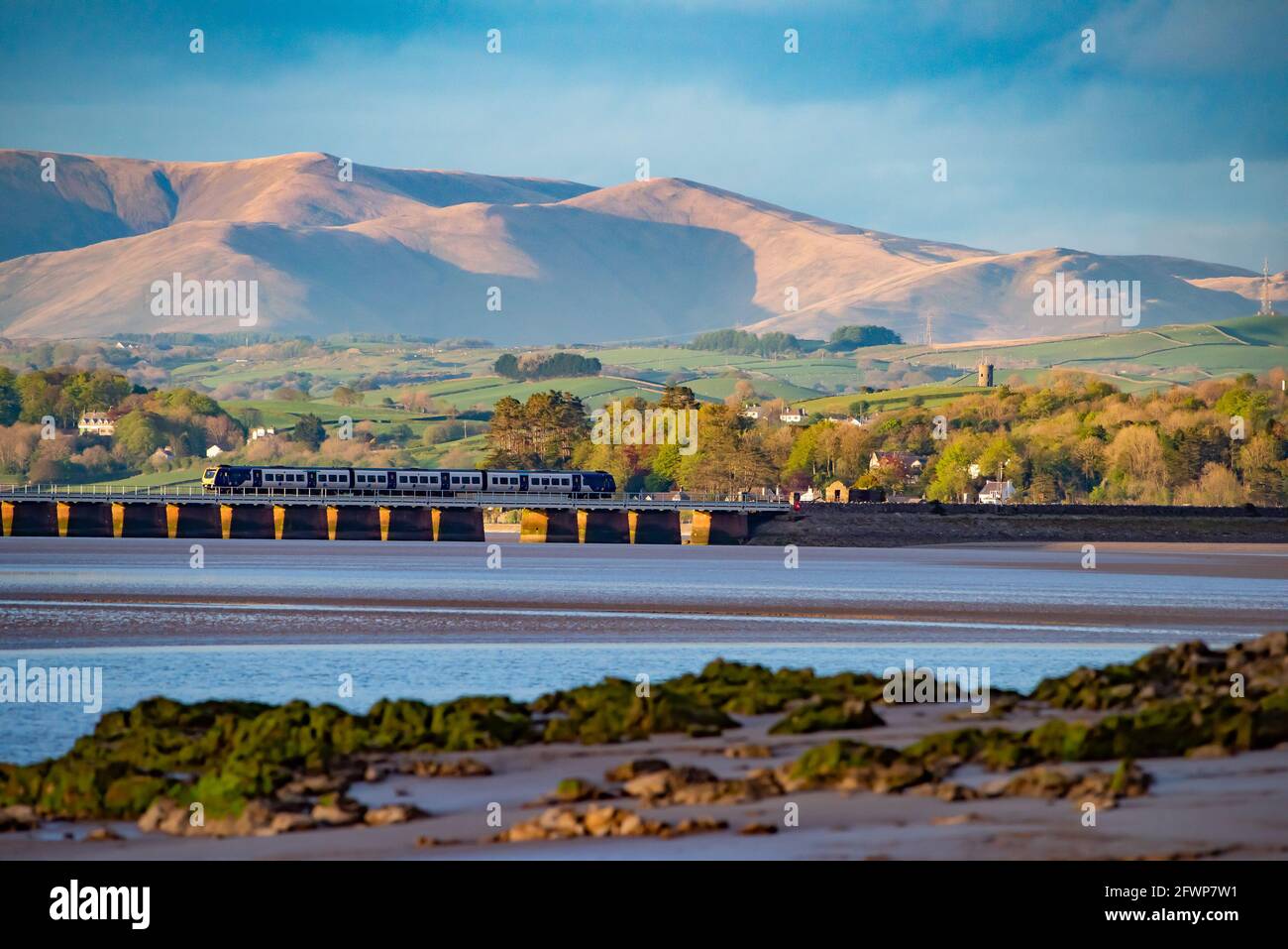 View of Arnside viaduct over the Kent Estuary towards the Yorkshire Dales fells from Arnside, Milnthorpe, Cumbria, UK. Stock Photo
