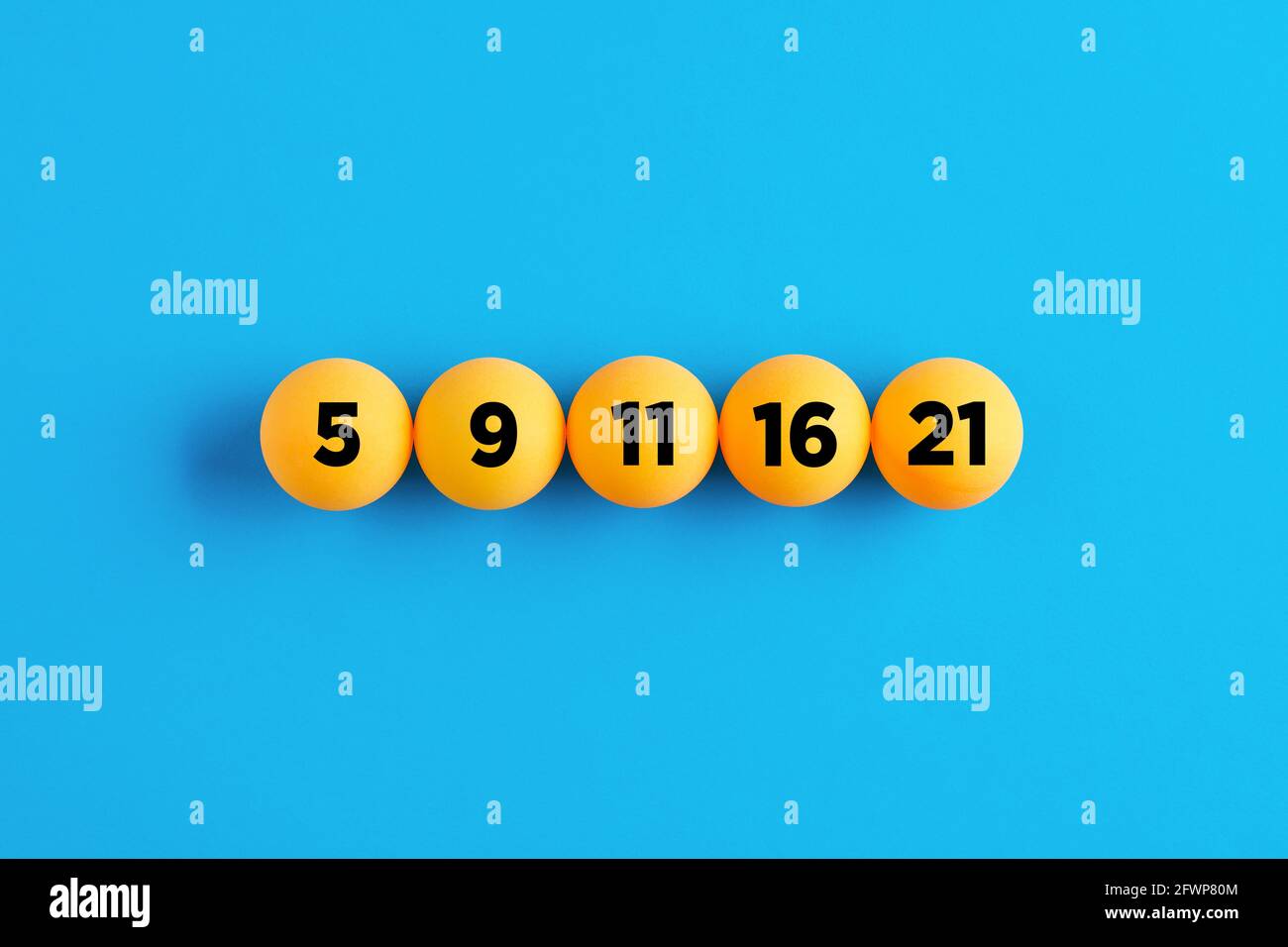 Lucky lottery numbers in a row on yellow balls on blue background
