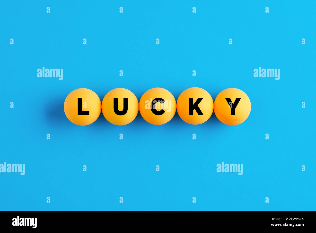 The Word Lucky Written On Yellow Bingo Or Lottery Balls On Blue 