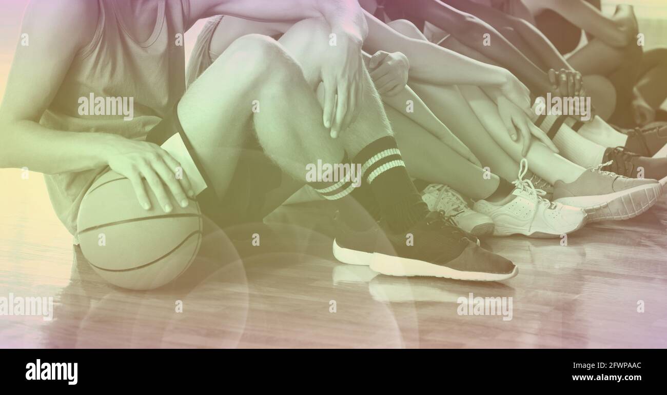 Composition of low section of team of school basketball players with green tint Stock Photo